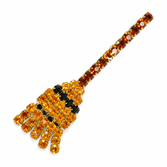 Broom brooch on white