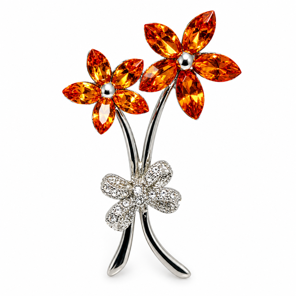Orange rhinestone flower brooch on white background