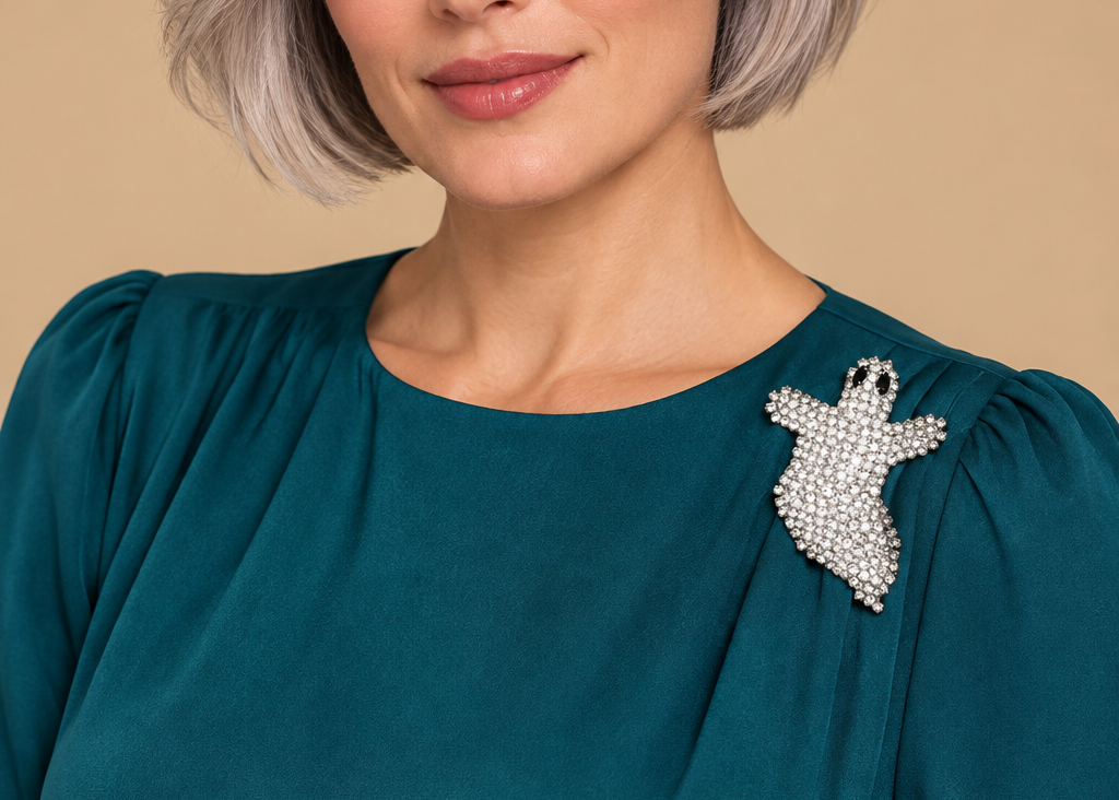 Model wearing silver-tone flying ghost rhinestone brooch