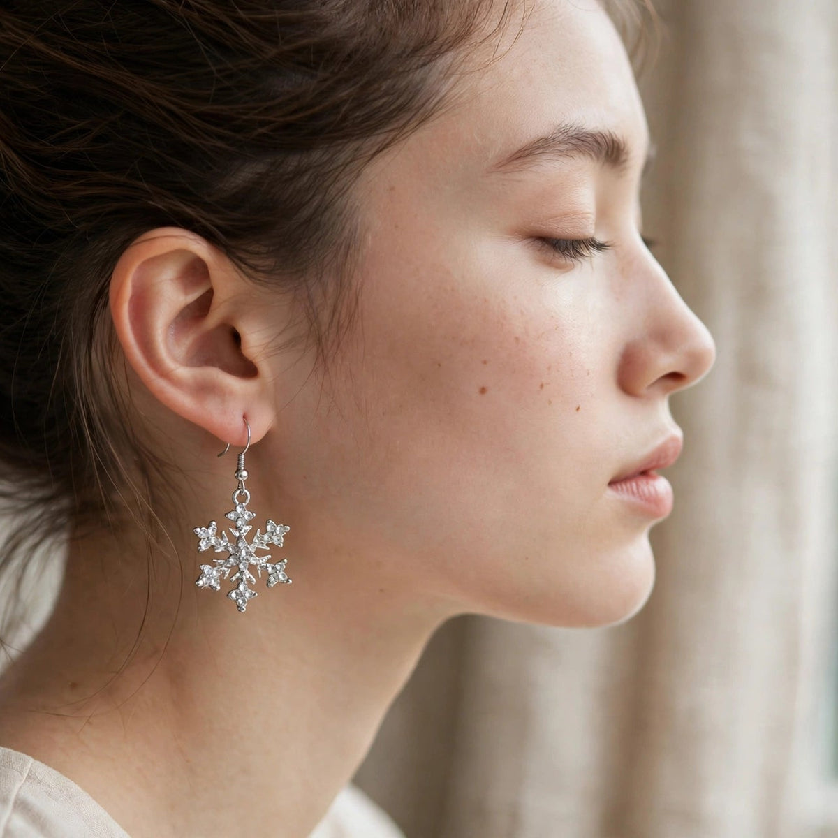 Silver-plated rhinestone snowflake dangle earrings, detail view