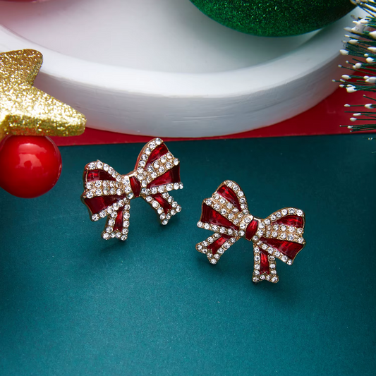 Pair of red crystal bow holiday earrings with gold-tone trim